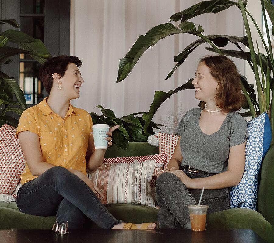 Two PBA students talk in a coffee shop.